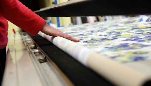 Roller blind fabric being rolled out in our factory ready for cutting - Blinds Norfolk - Norwich Sunblinds